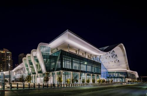 a large building with a glass facade at night at Bposhtels Las Vegas in Las Vegas