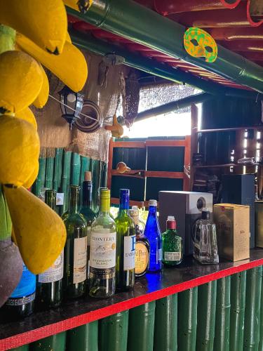 a group of bottles of wine sitting on a counter at Eco Hotel las Palmas in Armenia