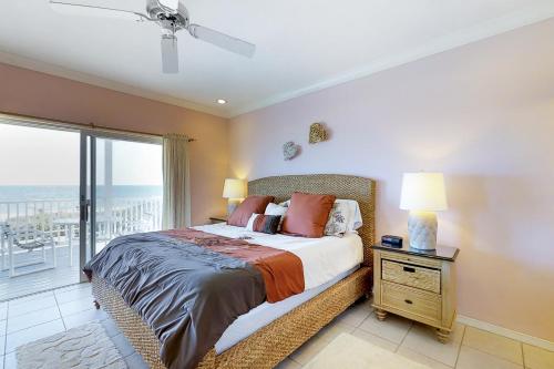 a bedroom with a bed with a view of the ocean at King's Crown in St. George Island