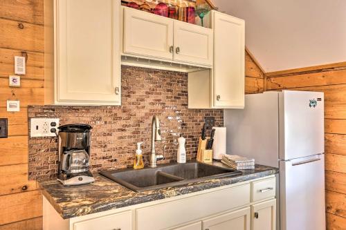 a kitchen with a sink and a refrigerator at Quaint Studio with Shared Beach Walk to Suttons Bay in Suttons Bay