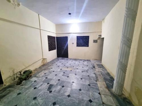 an empty room with a tile floor in a building at Remarkable 3-Bedroom in Gūjar Khān