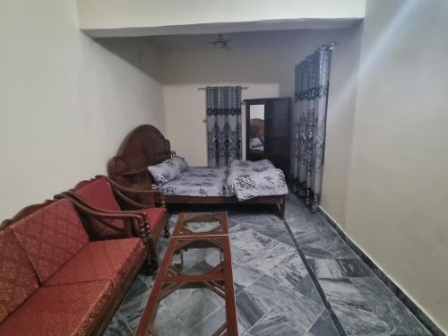 a living room with a couch and a table at Remarkable 3-Bedroom in Gūjar Khān