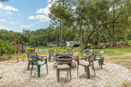 a group of chairs around a table and a fire pit at Family Forest Retreat, Paradise at Point Pleasant! in Salt Springs
