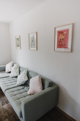 a living room with a couch with pillows on it at Meadows House Lomnice in Lomnice