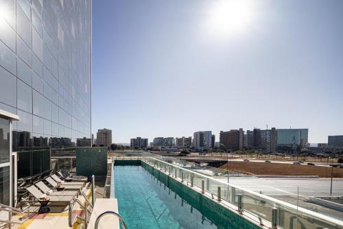 a swimming pool on the side of a building at Ramada by Wyndham Brasilia Alvorada in Brasilia