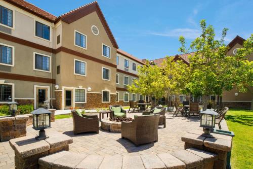 a courtyard with chairs and tables and a building at Sonesta ES Suites San Diego - Rancho Bernardo in Rancho Bernardo