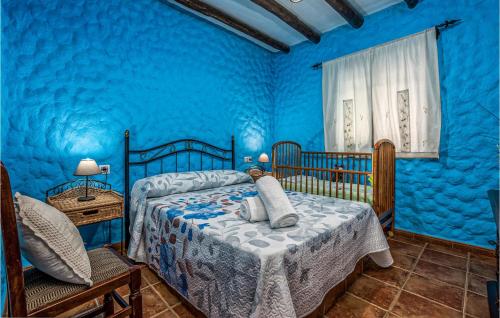 ein blaues Schlafzimmer mit 2 Betten und einer blauen Wand in der Unterkunft Cozy Home In Algatocin With Kitchenette in Algatocín