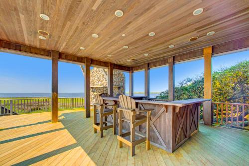 a large deck with a bar with chairs on it at Croatan Ridge 940 in Buxton