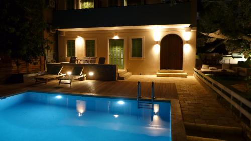 a swimming pool in a backyard at night at Caltabania Suites in Agios Nikitas