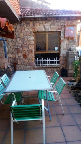 a picnic table and chairs on a patio at Casa, rural A Saladina in Soria