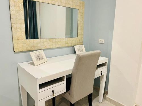 a white desk with a mirror and a chair at Noè Hotel 1 king bedroom # 10 in Punta Cana