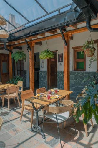 a patio with a wooden table and chairs at Masaya Bogotá in Bogotá