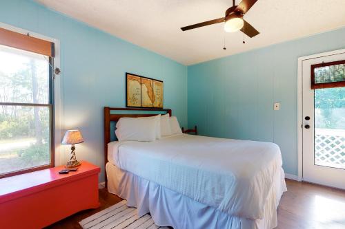 a bedroom with a bed and a ceiling fan at Our Anchor in St. George Island
