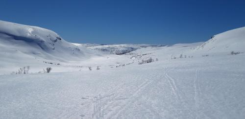 a snow covered mountain with tracks in the snow at Stalheim Fjord og Fjellhytter in Stalheim