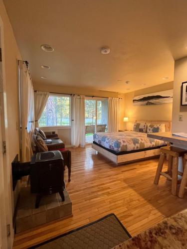 a bedroom with a bed and a desk in a room at River Run Inn in Winthrop