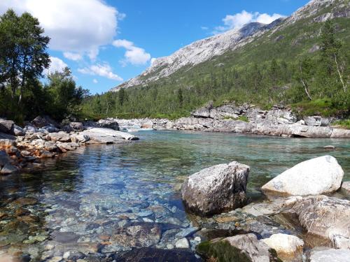 a river in the mountains with rocks in the water at Stalheim Fjord og Fjellhytter in Stalheim