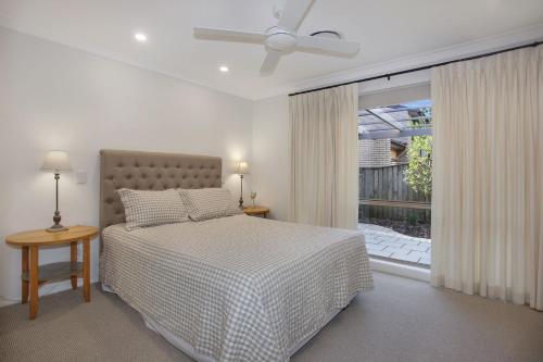 a bedroom with a bed and a large window at Vitamin Sea Pet Friendly in Hawks Nest
