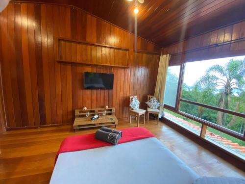 1 dormitorio con cama y ventana grande en Casa do Mirante quarto 301 en Florianópolis