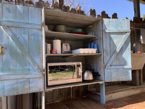 an old wooden door with a mirror on a shelf at Luxury 6 metre Bell Tent & Outdoor Bathroom, WIFI, TV and firepit, in Coodanup