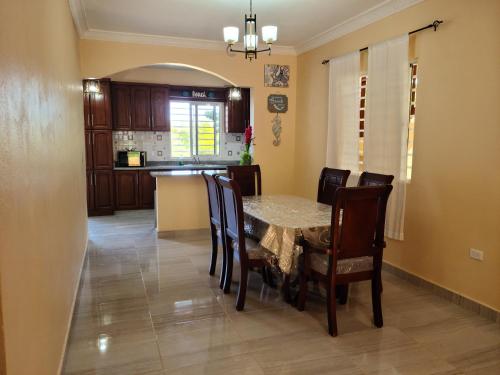 a kitchen and dining room with a table and chairs at Bongo Lodge in Las Galeras