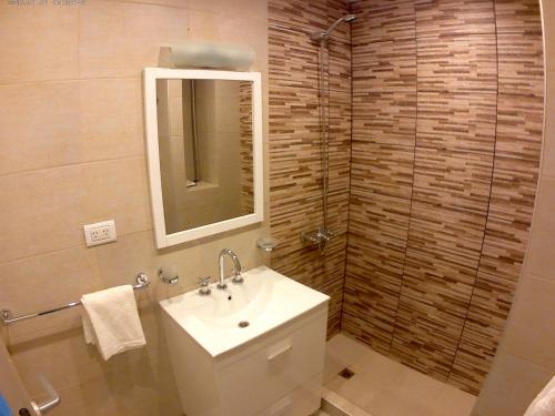 a bathroom with a sink and a mirror at Alumine in Puerto Madryn