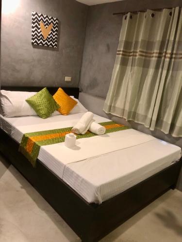 two beds sitting next to each other in a bedroom at RL Harbor Inn in El Nido