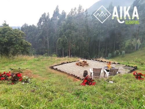 a group of people sitting in chairs in a field at AIKA Reserva Glamping Tabio in Tabio