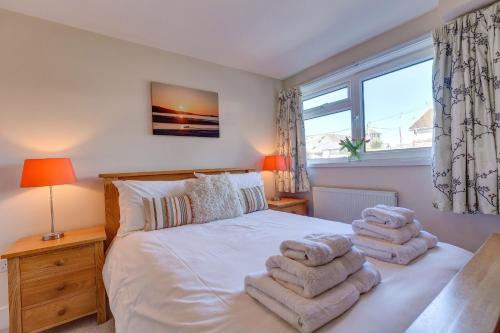 a bedroom with a bed with towels on it at Sowena in Carbis Bay