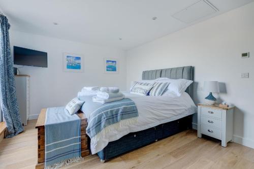 a bedroom with a bed and a night stand at Sea Vista in Carbis Bay