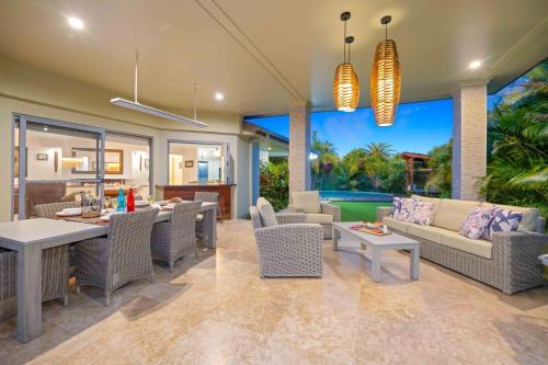 a living room with a couch and a table at Riverside Breeze - luxury family retreat with pool in Port Macquarie