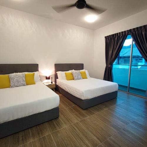 1 dormitorio con 2 camas y ventana en W39WarmStay@GoldenHills/NightMarket/4R/BBQ en Brinchang