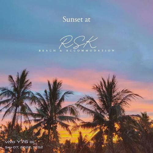 a group of palm trees against a sunset at RSK Beach and Accommodation in Dapa