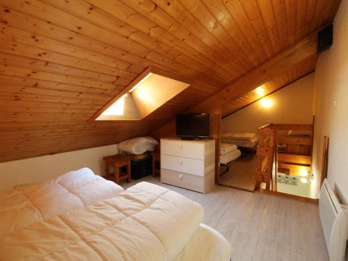 a bedroom with a large white bed in a wooden ceiling at Studio Les Carroz d'Arâches, 1 pièce, 4 personnes - FR-1-572-60 in Arâches-la-Frasse