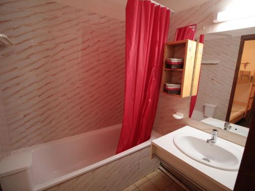 a bathroom with a sink and a red shower curtain at Appartement Les Carroz d'Arâches, 2 pièces, 4 personnes - FR-1-572-87 in Arâches-la-Frasse