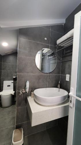 a bathroom with a tub and a toilet and a mirror at Raon THT Hotel in Da Lat