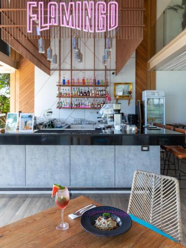 a restaurant with a table with a plate of food at Bandara Beach Resort, Phuket in Panwa Beach