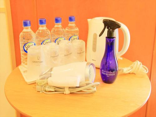 a table with a hair dryer and bottles of water at Hotel Sunset Terrace in Chatan