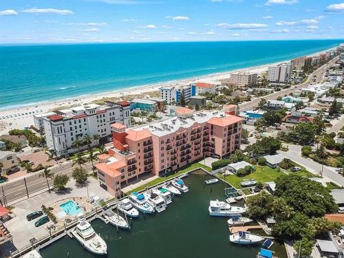 an aerial view of a marina with boats in the water at Gulf Coast Gold Private Condo - 2bed, 2bath, Sleep 6, Across Street from Beach, Balcony Views Of Sunsets, Beach & Gulf, Pool, Gym in St Pete Beach