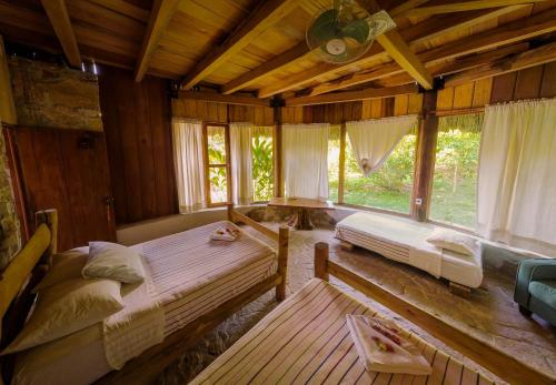 1 Schlafzimmer mit 2 Betten in einem Zimmer mit Fenstern in der Unterkunft Eco Hotel Sak Nok in Lacanjá