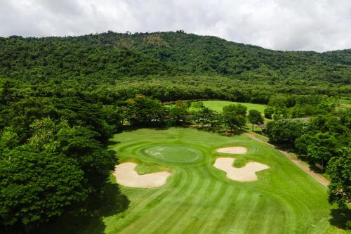 an overhead view of a golf course with a green at Kirimaya Golf Resort Spa - SHA Plus Certified in Mu Si