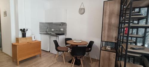 a small kitchen with a table and chairs in a room at Appartment in Bakuriani in Bakuriani