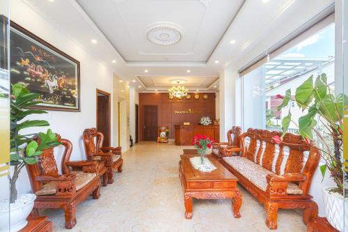 a living room with couches and a table and chairs at Villa Hoa Ly Đà Lạt in Da Lat