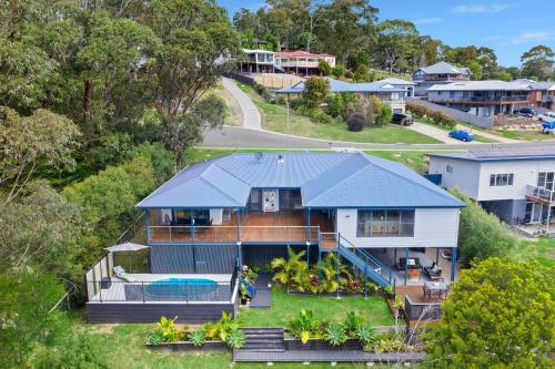 an aerial view of a house with a swimming pool at Blue Haven in Kianga