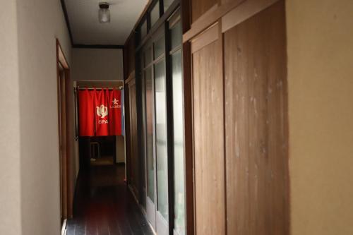 a hallway with a chinese flag in the background at Daibutsu Ryokan in Takaoka