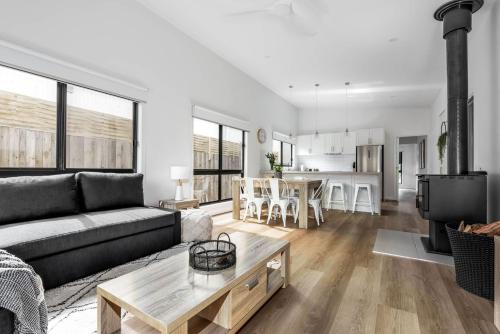 a living room with a couch and a table at The House with the Orange Door, Inverloch in Inverloch