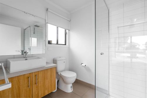 a bathroom with a toilet and a sink and a shower at The house with the orange door Inverloch in Inverloch