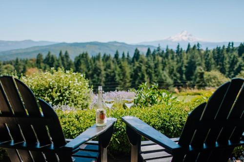 two chairs and a bottle of wine sitting on a table at Sakura Ridge Farm & Lodge in Hood River