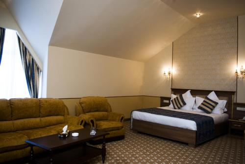 a hotel room with a bed and a couch at Multi Rest House in Tsaghkadzor