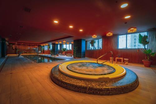 a large room with a hot tub in the middle of a building at Melia Valencia in Valencia