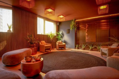 a large living room with a large rug and chairs at Melia Valencia in Valencia